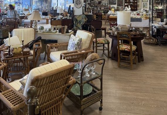 Wicker and rattan seating with lamps and a glass-topped bar cart