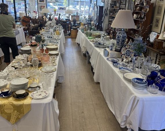 Fine china and crystal on white-draped tables